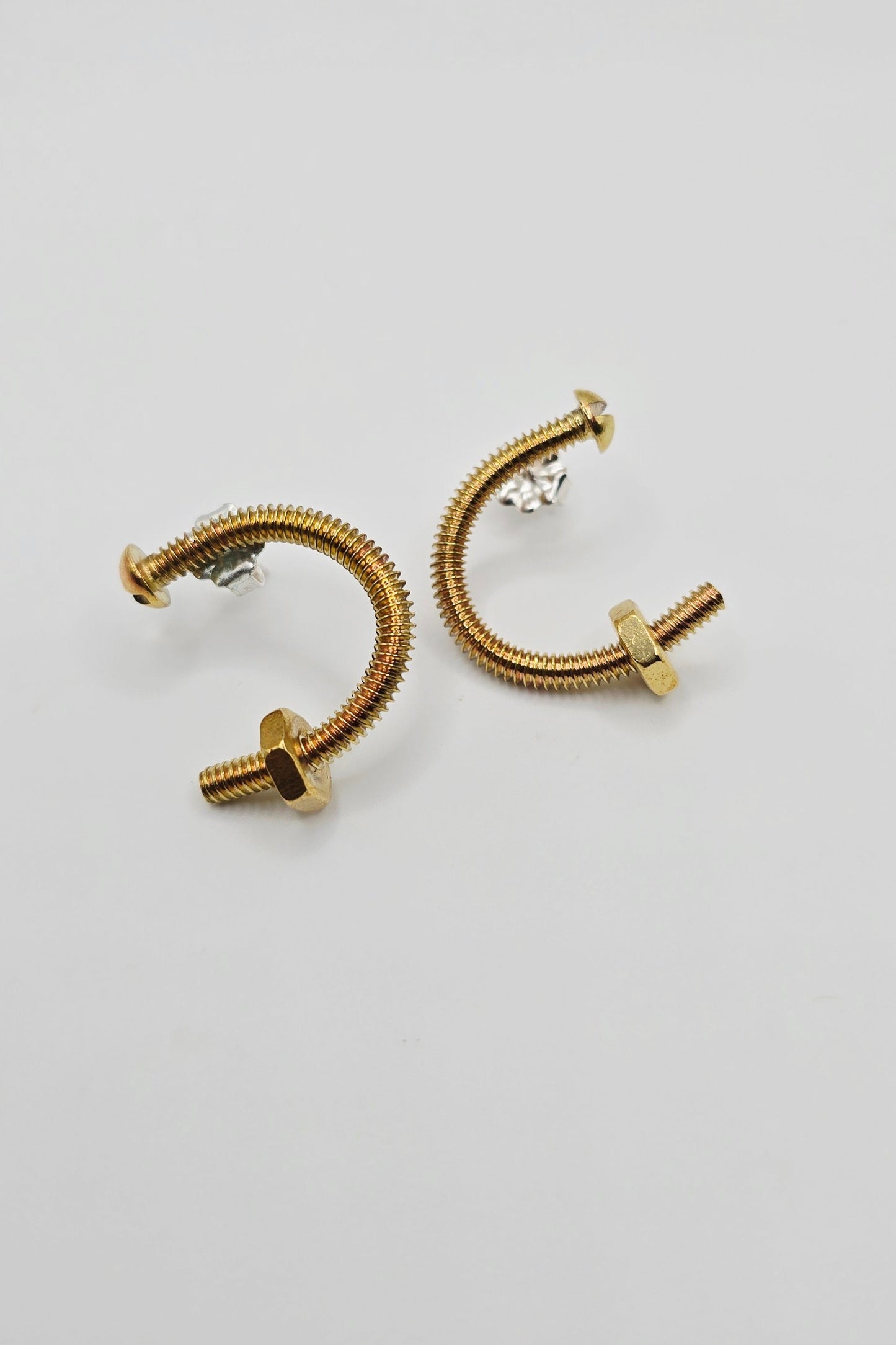 Unique brass screw earrings by Jill Melyssa with real nuts. Sterling silver ear posts