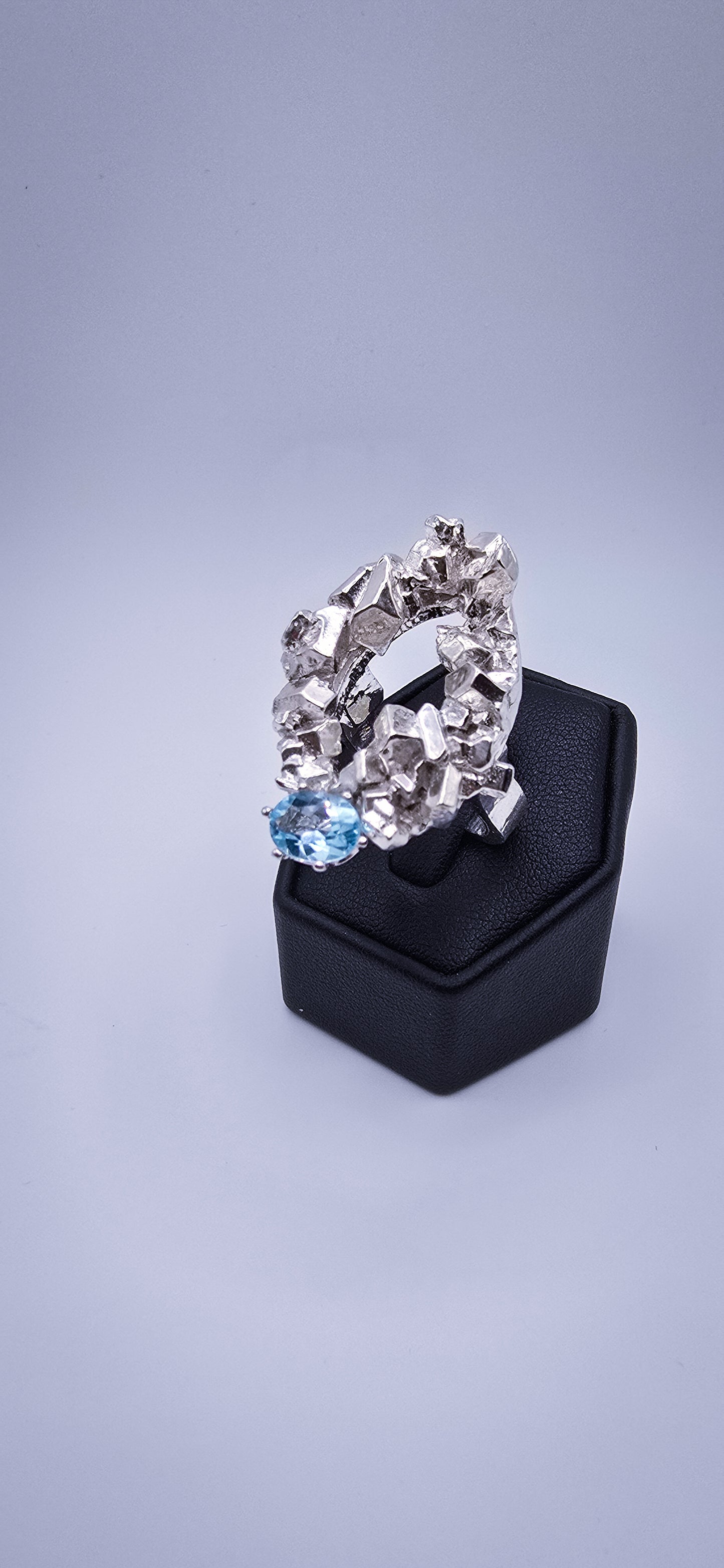 Solid sterling silver cocktail ring with a rock texture and features a sky blue topaz gemstone. Size 6.5 Made by Jill Melyssa