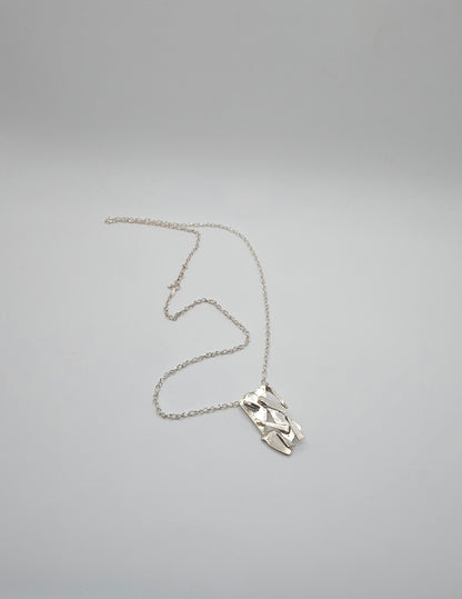 Made from shards of broken glass, this sterling silver pendant has a unique pattern. Comes on a 20" sterling chain. Made by Jill Melyssa