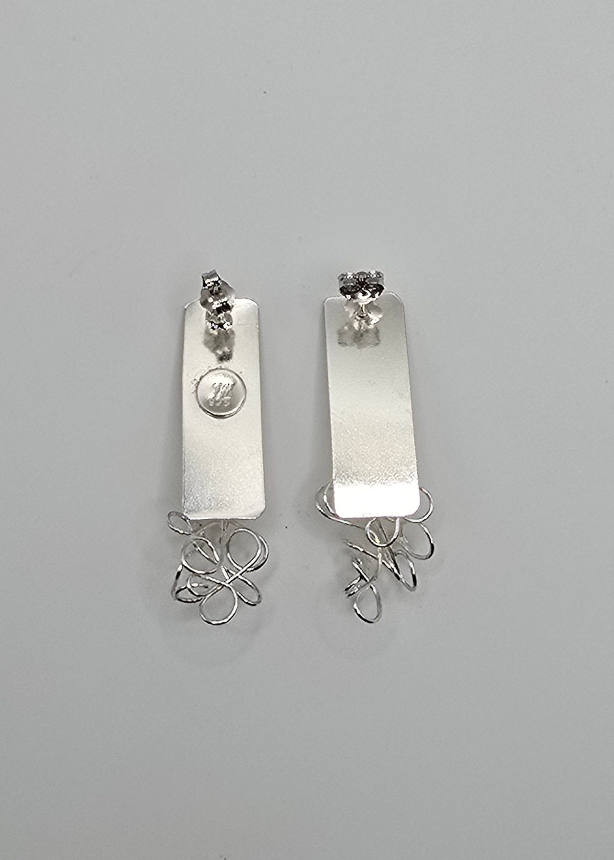 Coexistence sculptural sterling silver earrings featuring organic, freeform wire paired with smooth, geometric sheet metal forms, from Jill Melyssa’s Two Truths collection.