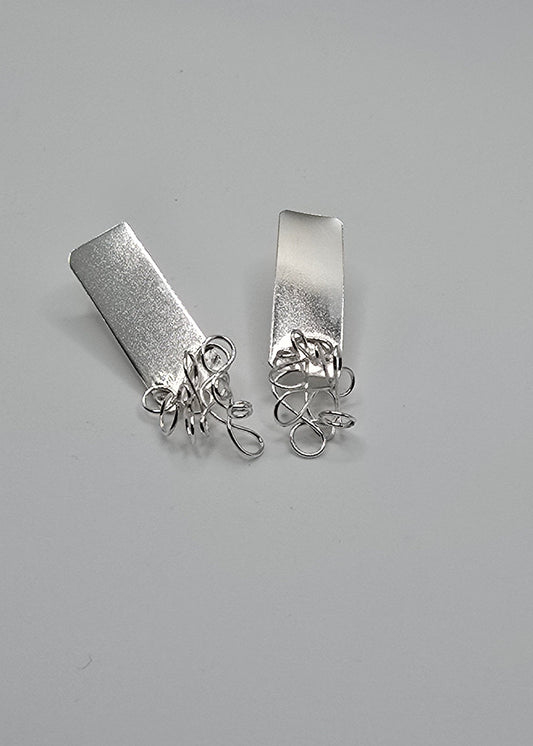 Coexistence sculptural sterling silver earrings featuring organic, freeform wire paired with smooth, geometric sheet metal forms, from Jill Melyssa’s Two Truths collection.