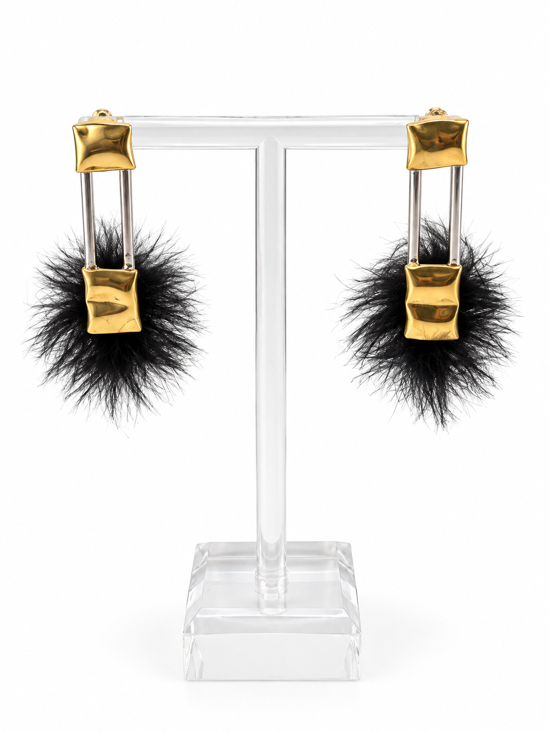 Comfort & Void sculptural earrings featuring rounded brass pillow like forms and soft black faux fur, from Jill Melyssa’s Two Truths Collection.