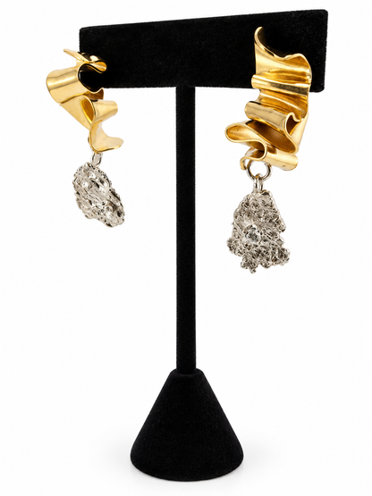 Side view of Duality sculptural sterling silver and brass earrings with irregular silver pendants and sparkling 3mm cubic zirconia details.