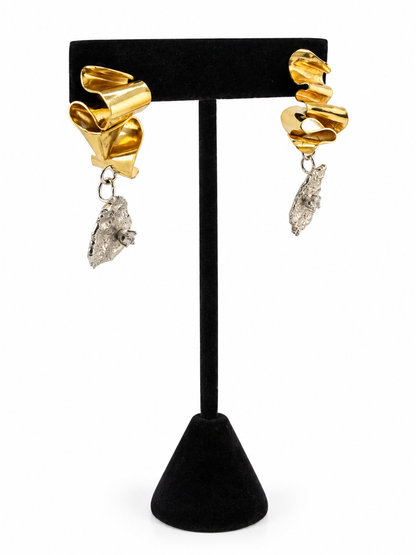 Close up of Duality mixed metal earrings showing the contrast between smooth, flowing brass and organically textured sterling silver, accented with 3mm cubic zirconia.