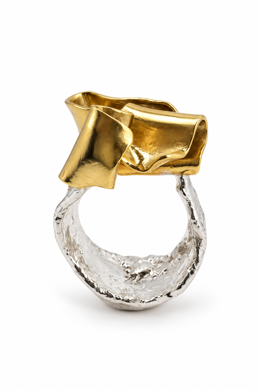 Duality sculptural sterling silver and brass ring featuring a pounded, textured silver band and smooth, flowing brass ribbon form, from Jill Melyssa’s Two Truths Collection.