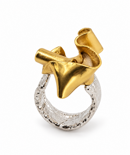 Close up of the Duality mixed metal sculptural ring, highlighting the contrast between the gritty, pounded sterling silver band and smooth brass form.