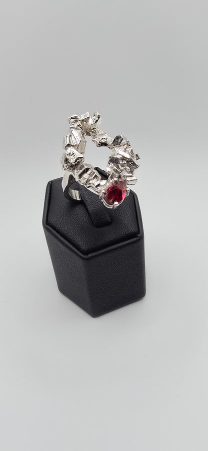 Solid sterling silver cocktail ring with a rock texture and features a pear garnet gemstone. Size 6.5 Made by Jill Melyssa