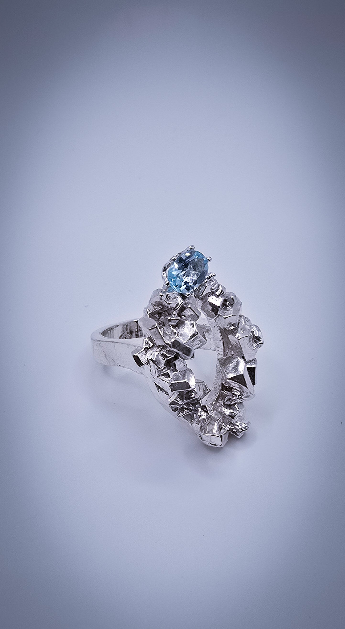 Solid sterling silver cocktail ring with a rock texture and features a sky blue topaz gemstone. Size 6.5 Made by Jill Melyssa