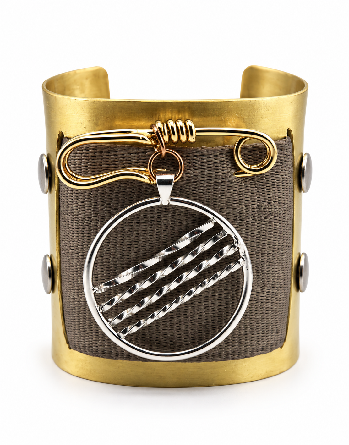 Front view of a one of a kind brass cuff bracelet with woven seat belt material, handcrafted brass safety pin, and large removable sterling silver pendant with diagonal textured detailing.